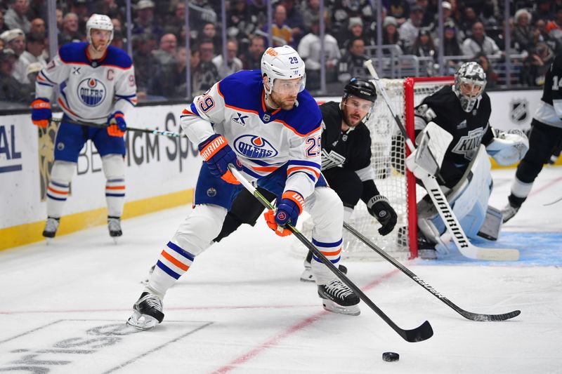 Apr 29, 2025; Los Angeles, California, USA; Edmonton Oilers center Leon Draisaitl (29) moves the puck against Los Angeles Kings right wing Adrian Kempe (9) during the first period in game five of the first round of the 2025 Stanley Cup Playoffs at Crypto.com Arena. Mandatory Credit: Gary A. Vasquez-Imagn Images
