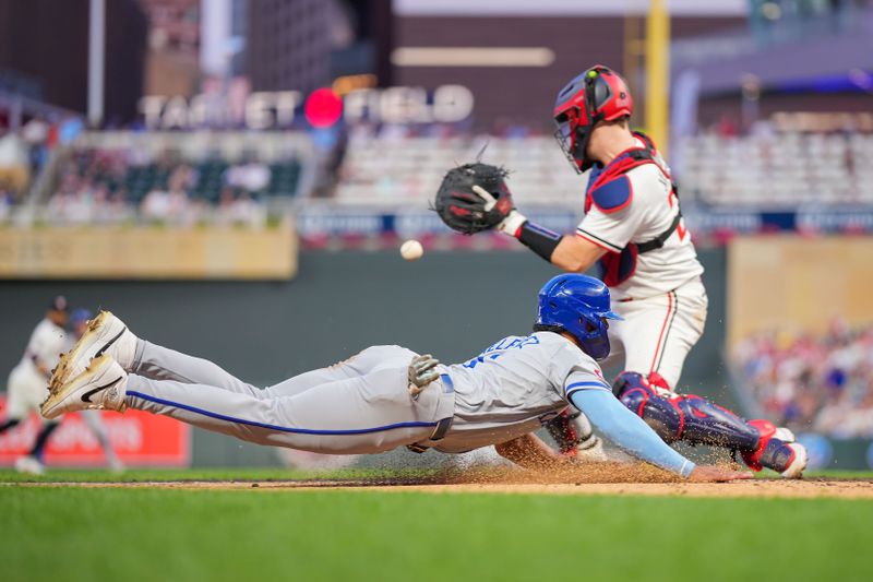 Aug 12, 2024; Minneapolis, Minnesota, USA; Kansas City Royals outfielder MJ Melendez (1) slides home against the Minnesota Twins catcher Ryan Jeffers (27) in the sixth inning at Target Field. Mandatory Credit: Brad Rempel-USA TODAY Sports