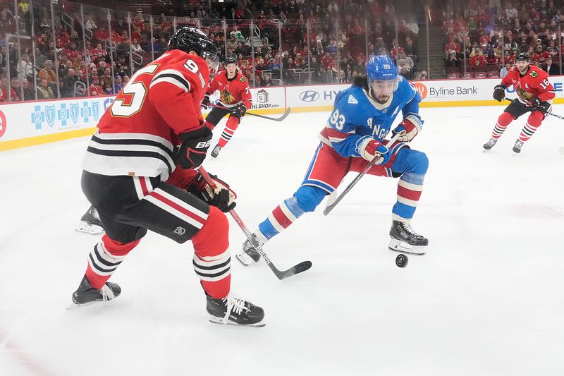 Dec 10, 2025; Chicago, Illinois, USA; Chicago Blackhawks right wing Ilya Mikheyev (95) and New York Rangers center Mika Zibanejad (93) go for the puck during the first period at United Center. Mandatory Credit: David Banks-Imagn Images