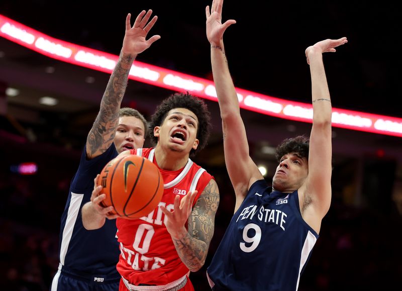Jan 26, 2026; Columbus, Ohio, USA; Ohio State Buckeyes guard John Mobley Jr. (0) is fouled by Penn State Nittany Lions guard Melih Tunca (9) and guard Eli Rice (left) during the second half at Value City Arena. Mandatory Credit: Joseph Maiorana-Imagn Images