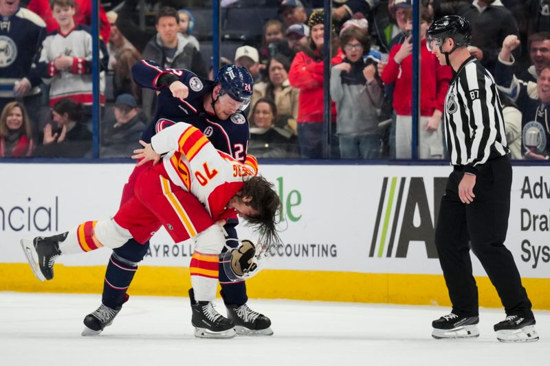 Nov 29, 2024; Columbus, Ohio, USA;  Columbus Blue Jackets right wing Mathieu Olivier (24) fights Calgary Flames left wing Ryan Lomberg (70) in the second period at Nationwide Arena. Mandatory Credit: Aaron Doster-Imagn Images