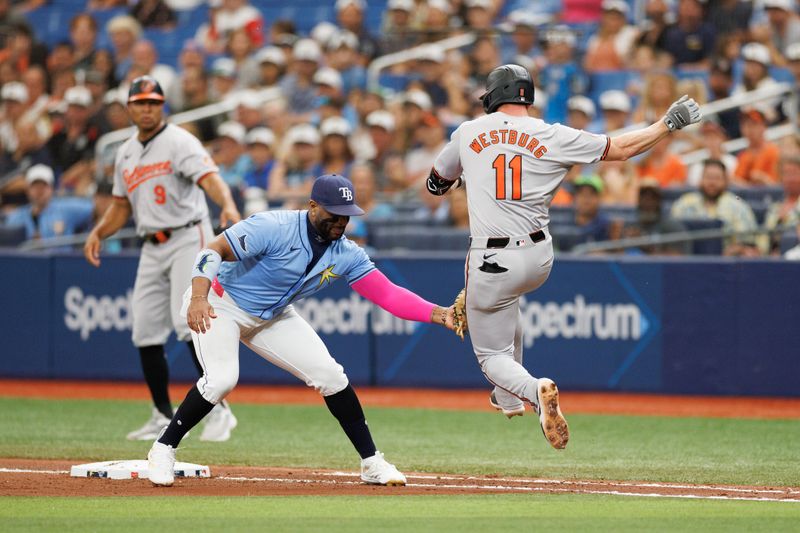 Jun 9, 2024; St. Petersburg, Florida, USA;  Tampa Bay Rays first baseman Yandy Diaz (2) tags out Baltimore Orioles second baseman Jordan Westburg (11) in the fourth inning at Tropicana Field. Mandatory Credit: Nathan Ray Seebeck-USA TODAY Sports