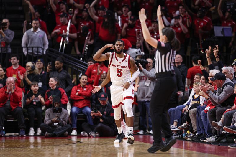 Feb 1, 2025; Piscataway, New Jersey, USA; Rutgers Scarlet Knights guard Tyson Acuff (5) reacts after making a three point basket during the first half against the Michigan Wolverines at Jersey Mike's Arena. Mandatory Credit: Vincent Carchietta-Imagn Images