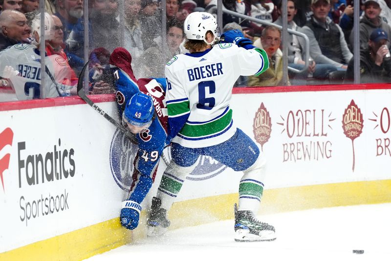 Feb 20, 2024; Denver, Colorado, USA; Vancouver Canucks right wing Brock Boeser (6) is hip checked by Colorado Avalanche defenseman Samuel Girard (49) in the first period at Ball Arena. Mandatory Credit: Ron Chenoy-USA TODAY Sports