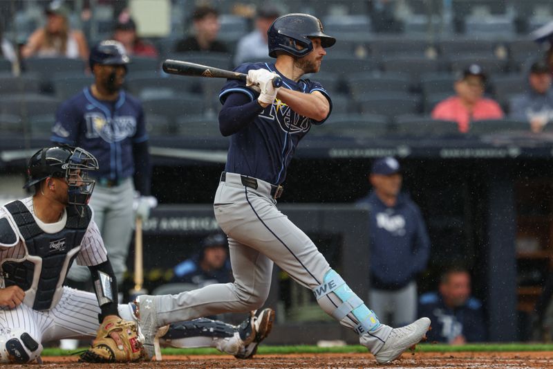 May 4, 2025; Bronx, New York, USA; Tampa Bay Rays second baseman Brandon Lowe (8) hits a two run singles during the fourth inning against the New York Yankees at Yankee Stadium. Mandatory Credit: Vincent Carchietta-Imagn Images