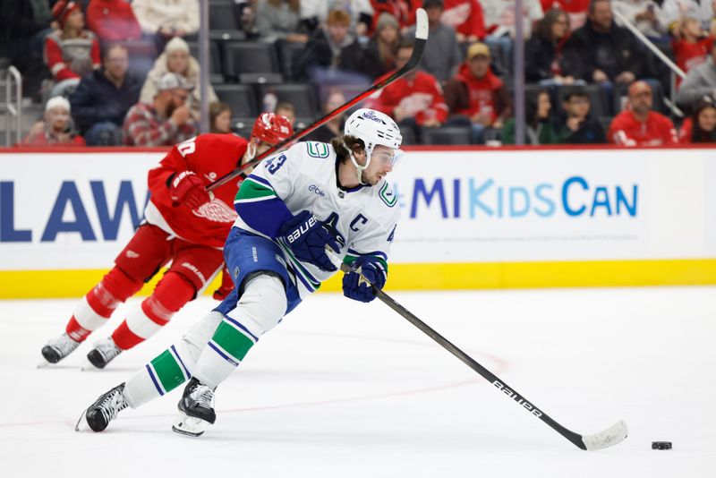 Dec 1, 2024; Detroit, Michigan, USA;  Vancouver Canucks defenseman Quinn Hughes (43) skates with the puck in the second period against the Detroit Red Wings at Little Caesars Arena. Mandatory Credit: Rick Osentoski-Imagn Images