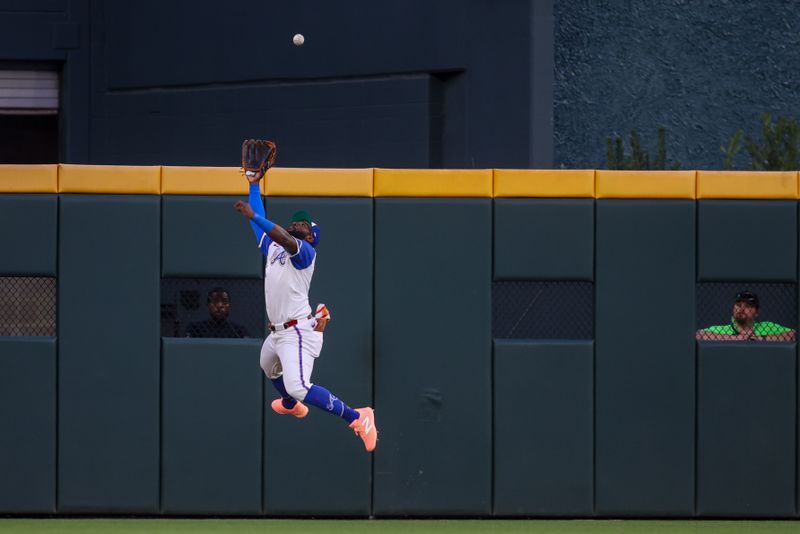 Apr 19, 2025; Atlanta, Georgia, USA; Atlanta Braves center fielder Michael Harris II (23) jumps for a ball against the Minnesota Twins in the third inning at Truist Park. Mandatory Credit: Brett Davis-Imagn Images