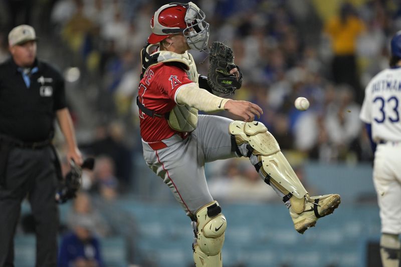 May 16, 2025; Los Angeles, California, USA; Los Angeles Angels catcher Logan O'Hoppe (14) attempts to throw a runner out at second in the eighth inning against the Los Angeles Dodgers at Dodger Stadium. Mandatory Credit: Jayne Kamin-Oncea-Imagn Images