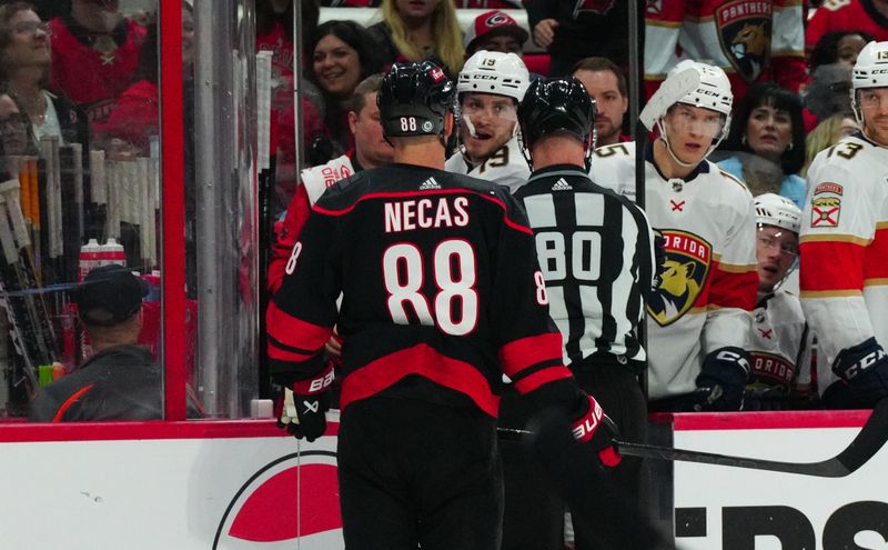 Mar 14, 2024; Raleigh, North Carolina, USA; Florida Panthers left wing Matthew Tkachuk (19) and Carolina Hurricanes center Martin Necas (88) have words during the second period at PNC Arena. Mandatory Credit: James Guillory-USA TODAY Sports