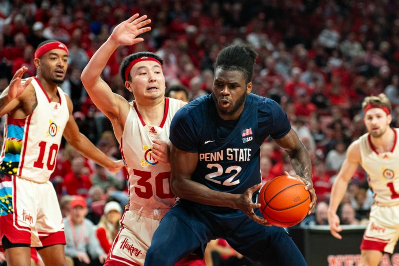 Feb 17, 2024; Lincoln, Nebraska, USA; Penn State Nittany Lions forward Qudus Wahab (22) drives against Nebraska Cornhuskers guard Keisei Tominaga (30) during the second half at Pinnacle Bank Arena. Mandatory Credit: Dylan Widger-USA TODAY Sports