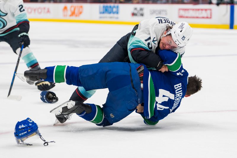 Sep 29, 2022; Vancouver, British Columbia, CAN; Vancouver Canucks defenseman Kyle Burroughs (44) fights with Seattle Kraken forward John Hayden (15) in the first period at Rogers Arena. Mandatory Credit: Bob Frid-USA TODAY Sports