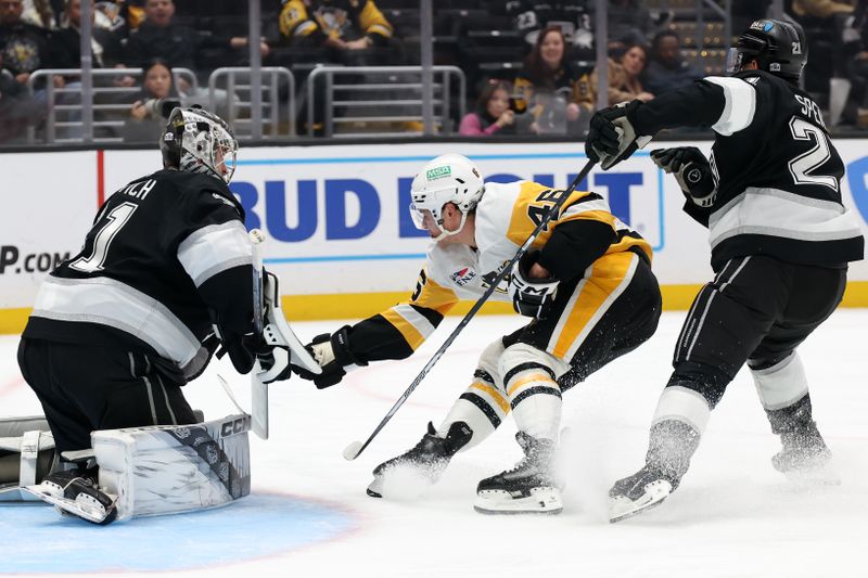 Jan 20, 2025; Los Angeles, California, USA;  Pittsburgh Penguins center Blake Lizotte (46) attempts to score a goal between  Los Angeles Kings goaltender David Rittich (31) and defenseman Jordan Spence (21) during the third period at Crypto.com Arena. Mandatory Credit: Kiyoshi Mio-Imagn Images