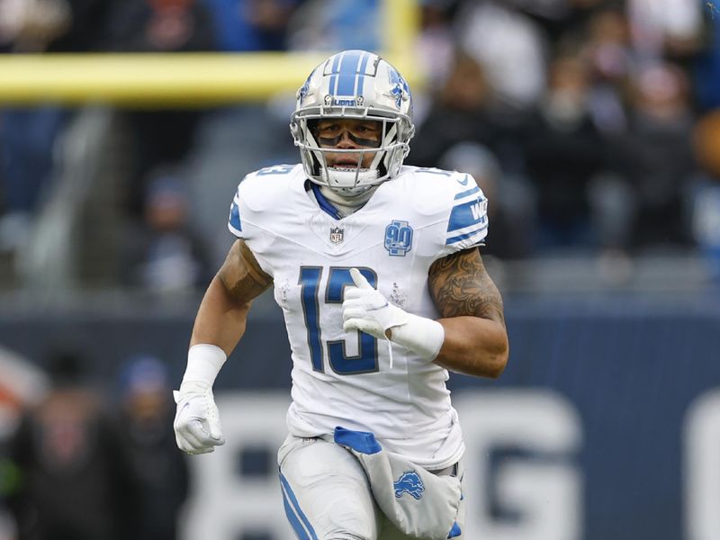 Detroit Lions running back Craig Reynolds (13) runs on the field during the first half of an NFL football game against the Chicago Bears, Sunday, Dec. 10, 2023, in Chicago. (AP Photo/Kamil Krzaczynski)