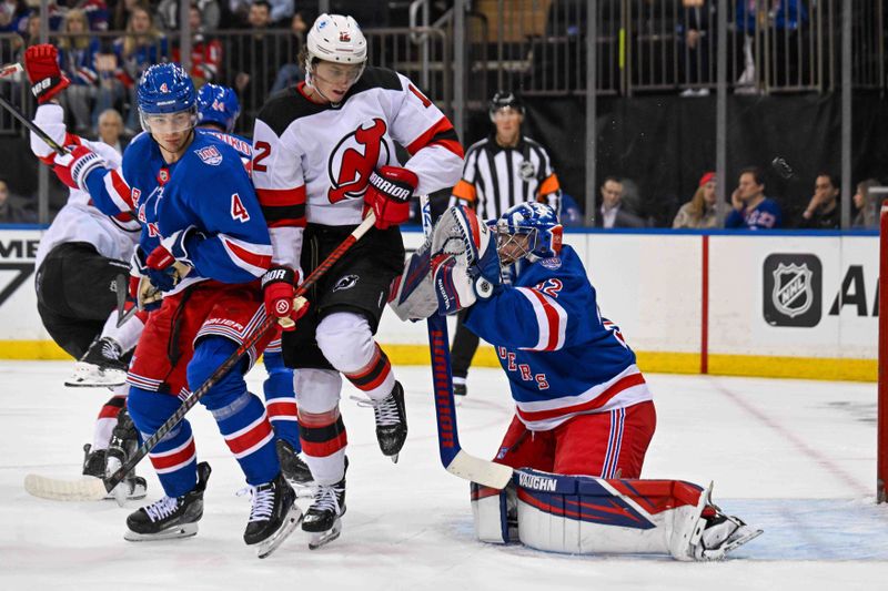 Oct 2, 2025; New York, New York, USA;  New Jersey Devils center Cody Glass (12) and New York Rangers defenseman Braden Schneider (4) battle in front of New York Rangers goaltender Jonathan Quick (32) during the first period at Madison Square Garden. Mandatory Credit: Dennis Schneidler-Imagn Images