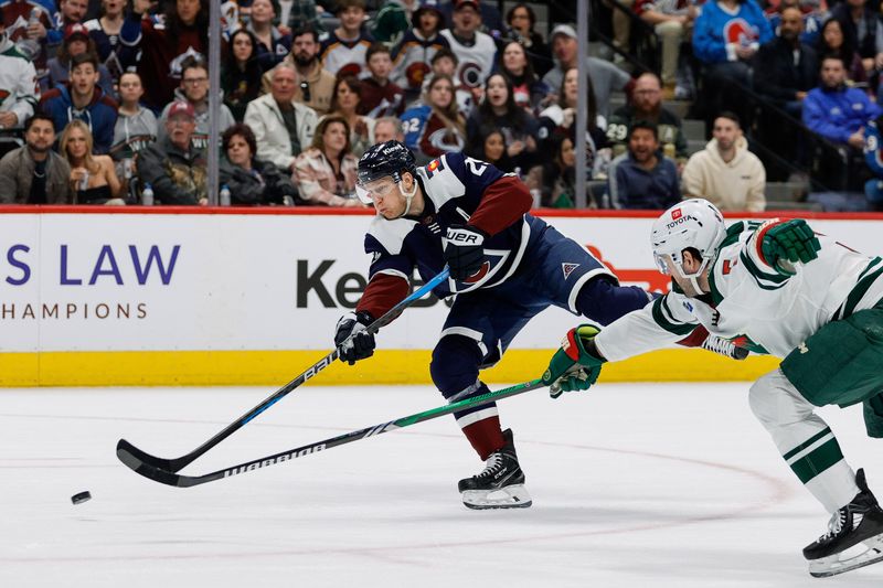 Apr 9, 2024; Denver, Colorado, USA; Colorado Avalanche center Nathan MacKinnon (29) scores on a shot as Minnesota Wild defenseman Jake Middleton (5) defends in the second period at Ball Arena. Mandatory Credit: Isaiah J. Downing-USA TODAY Sports