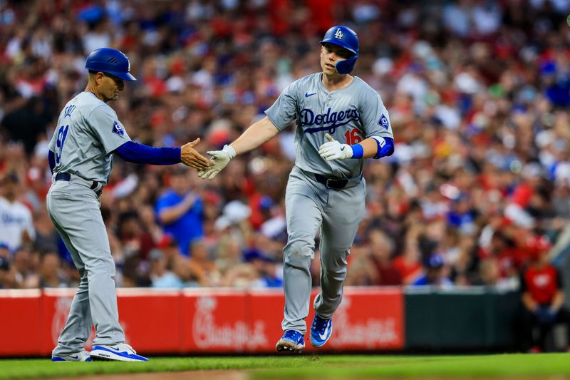 May 24, 2024; Cincinnati, Ohio, USA; Los Angeles Dodgers catcher Will Smith (16) high fives third base coach Dino Ebel (91) after hitting a solo home run in the fifth inning against the Cincinnati Reds at Great American Ball Park. Mandatory Credit: Katie Stratman-USA TODAY Sports