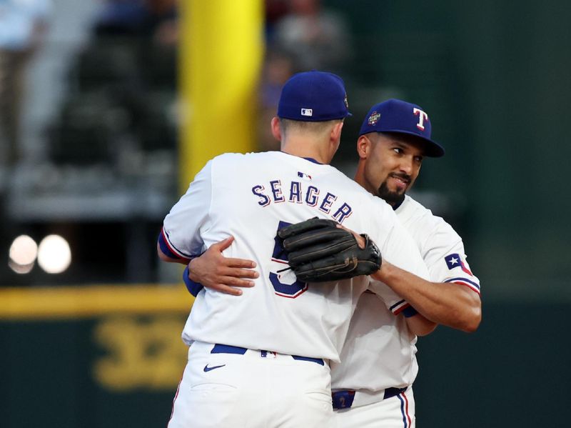 Jun 22, 2024; Arlington, Texas, USA; Texas Rangers shortstop Corey Seager (5) and second base Marcus Semien (2) celebrate after the game against the Kansas City Royals at Globe Life Field. Mandatory Credit: Tim Heitman-USA TODAY Sports