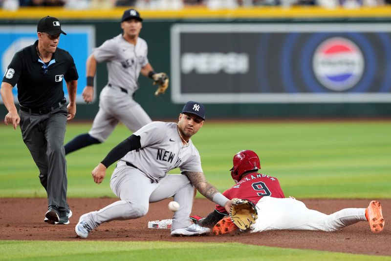 Apr 2, 2024; Phoenix, Arizona, USA; Arizona Diamondbacks shortstop Blaze Alexander (9) beats a throw to New York Yankees second baseman Gleyber Torres (25) to steal second base during the first inning at Chase Field. Mandatory Credit: Joe Camporeale-USA TODAY Sports