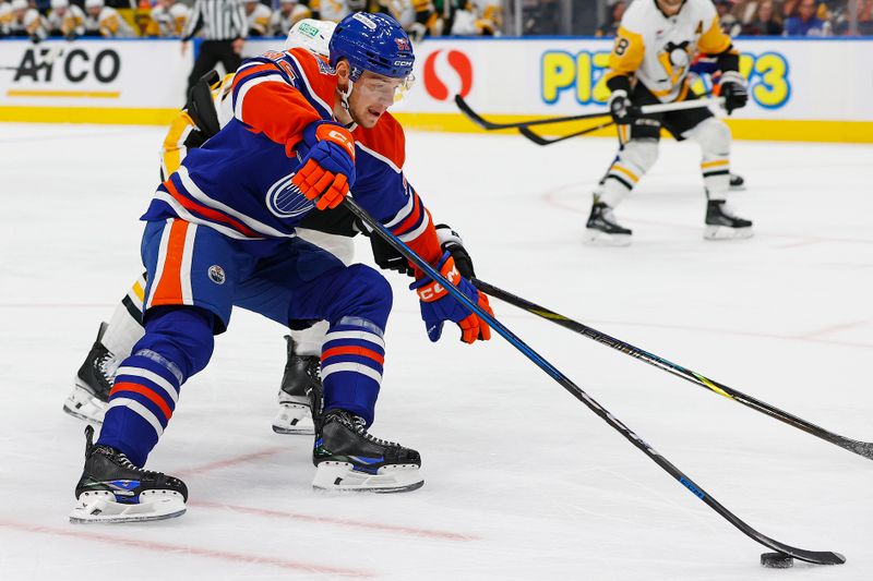 Oct 25, 2024; Edmonton, Alberta, CAN; Edmonton Oilers forward Vasily Podkolzin (92) carries the puck around Pittsburgh Penguins defensemen Marcus Pettersson (28) during the first period at Rogers Place. Mandatory Credit: Perry Nelson-Imagn Images