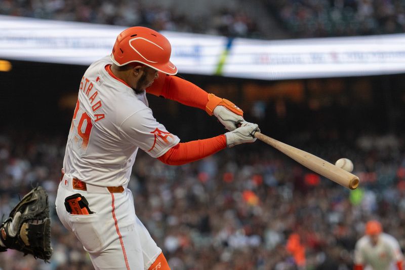 May 28, 2024; San Francisco, California, USA;  San Francisco Giants second base Thairo Estrada (39) hits a single during the fourth inning against the Philadelphia Phillies at Oracle Park. Mandatory Credit: Stan Szeto-USA TODAY Sports