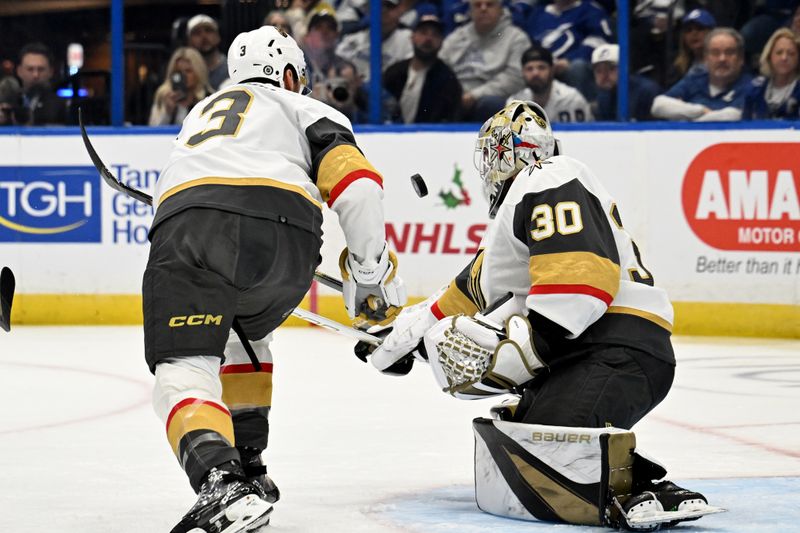 Dec 21, 2023; Tampa, Florida, USA; Las Vegas Golden Knights goaltender Jiri Patera (30) blocks a shot on goal in the first period against the Tampa Bay Lightning at Amalie Arena. Mandatory Credit: Jonathan Dyer-USA TODAY Sports