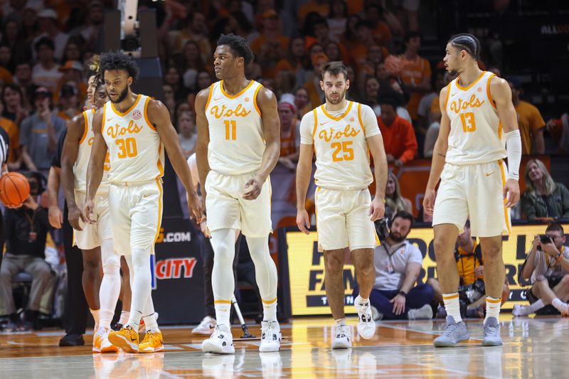 Feb 28, 2023; Knoxville, Tennessee, USA; Tennessee Volunteers guard Josiah-Jordan James (30), forward Tobe Awaka (11), guard Santiago Vescovi (25) and forward Olivier Nkamhoua (13) during the first half against the Arkansas Razorbacks at Thompson-Boling Arena. Mandatory Credit: Randy Sartin-USA TODAY Sports