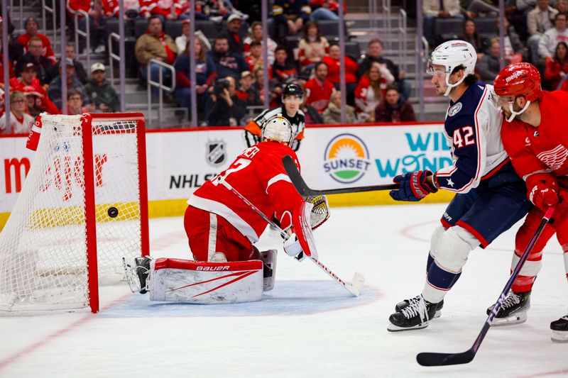 Mar 19, 2024; Detroit, Michigan, USA; Columbus Blue Jackets center Alexandre Texier (42) scores a goal during the first period of the game against the Detroit Red Wings at Little Caesars Arena. Mandatory Credit: Brian Bradshaw Sevald-USA TODAY Sports