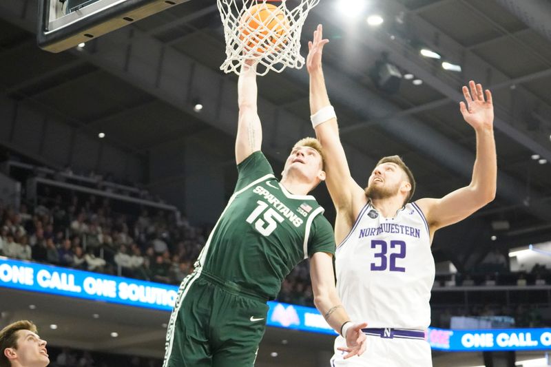 Jan 7, 2024; Evanston, Illinois, USA; Michigan State Spartans center Carson Cooper (15) goes up for a dunk on Northwestern Wildcats forward Blake Preston (32) during the first half at Welsh-Ryan Arena. Mandatory Credit: David Banks-USA TODAY Sports