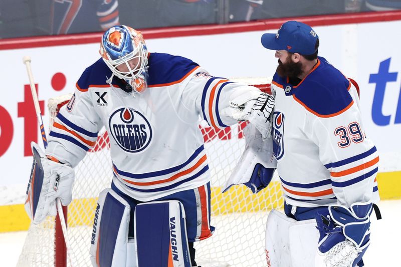 Dec 29, 2025; Winnipeg, Manitoba, CAN; Edmonton Oilers goaltender Calvin Pickard (30) and Edmonton Oilers goaltender Connor Ingram (39) celebrate their victory over the Winnipeg Jets at Canada Life Centre. Mandatory Credit: James Carey Lauder-Imagn Images