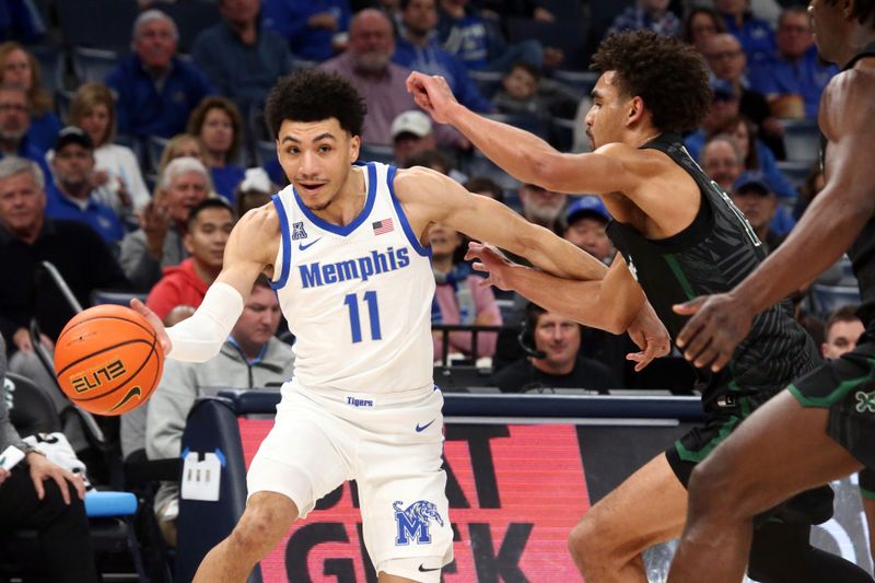 Feb 11, 2024; Memphis, Tennessee, USA; Memphis Tigers guard Jahvon Quinerly (11) drives to the basket as Tulane Green Wave guard Tre' Williams (13) defends during the first half at FedExForum. Mandatory Credit: Petre Thomas-USA TODAY Sports