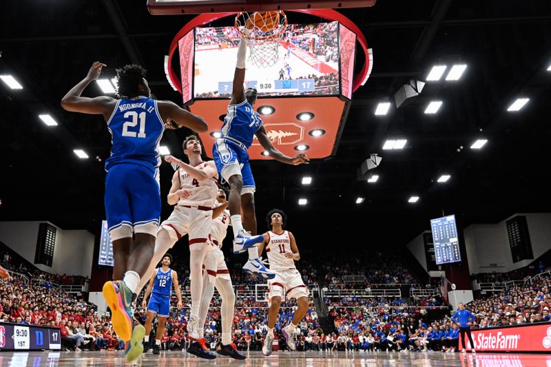 Jan 17, 2026; Stanford, California, USA; Duke Blue Devils guard Dame Sarr (7) dunks against Stanford Cardinal forward AJ Rohosy (4) in the first half at Maples Pavilion. Mandatory Credit: Eakin Howard-Imagn Images