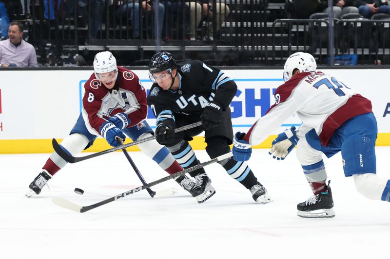 Oct 24, 2024; Salt Lake City, Utah, USA; Utah Hockey Club defenseman Michael Kesselring (7) skates between Colorado Avalanche defenseman Cale Makar (8) and defenseman Sam Malinski (70) during the third period at Delta Center. Mandatory Credit: Rob Gray-Imagn Images