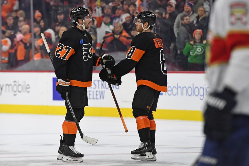 Jan 13, 2025; Philadelphia, Pennsylvania, USA; Philadelphia Flyers left wing Noah Cates (27) and Philadelphia Flyers defenseman Cam York (8) celebrate win against the Florida Panthers at Wells Fargo Center. Mandatory Credit: Eric Hartline-Imagn Images