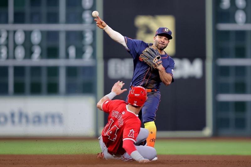 May 20, 2024; Houston, Texas, USA; Houston Astros second baseman Jose Altuve (27) throws a fielded ball to first base to complete a double play against the Los Angeles Angels during the fourth inning at Minute Maid Park. Mandatory Credit: Erik Williams-USA TODAY Sports
