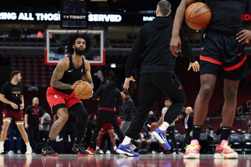 CHICAGO, ILLINOIS - NOVEMBER 11: Coby White (L) #0 of the Chicago Bulls takes a warm-up shot ahead of the Chicago Bulls home game against the Cleveland Cavaliers at the United Center on November 11, 2024 in Chicago, Illinois. NOTE TO USER: User expressly acknowledges and agrees that, by downloading and or using this photograph, User is consenting to the terms and conditions of the Getty Images License Agreement. (Photo by Geoff Stellfox/Getty Images)