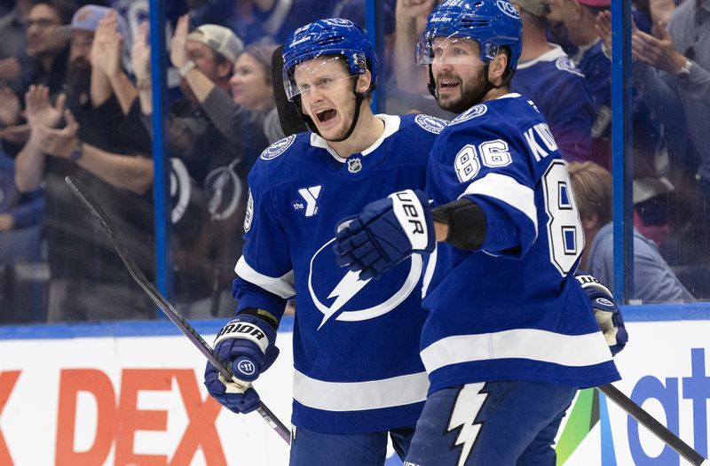 Oct 15, 2024; Tampa, Florida, USA; Tampa Bay Lightning right wing Nikita Kucherov (86) is congratulated by center Jake Guentzel (59) after he scored a goal against the Vancouver Canucks  during the first period at Amalie Arena. Mandatory Credit: Kim Klement Neitzel-Imagn Images