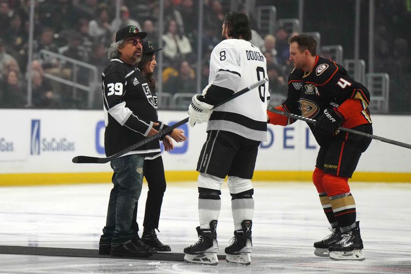 Apr 13, 2024; Los Angeles, California, USA; George Lopez and daughter Mayan Lopez shake hands with LA Kings defenseman Drew Doughty (8) and Anaheim Ducks defenseman Cam Fowler (4) before the game at Crypto.com Arena. Mandatory Credit: Kirby Lee-USA TODAY Sports