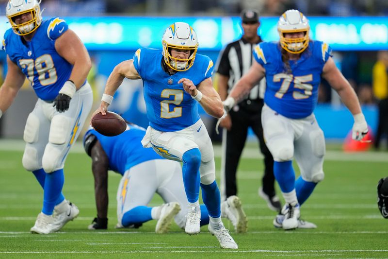 Los Angeles Chargers quarterback Easton Stick (2) carries for a gain in the second half of an NFL football game against the New Orleans Saints in Inglewood, Calif., Sunday, Aug. 20, 2023. (AP Photo/Marcio Jose Sanchez)