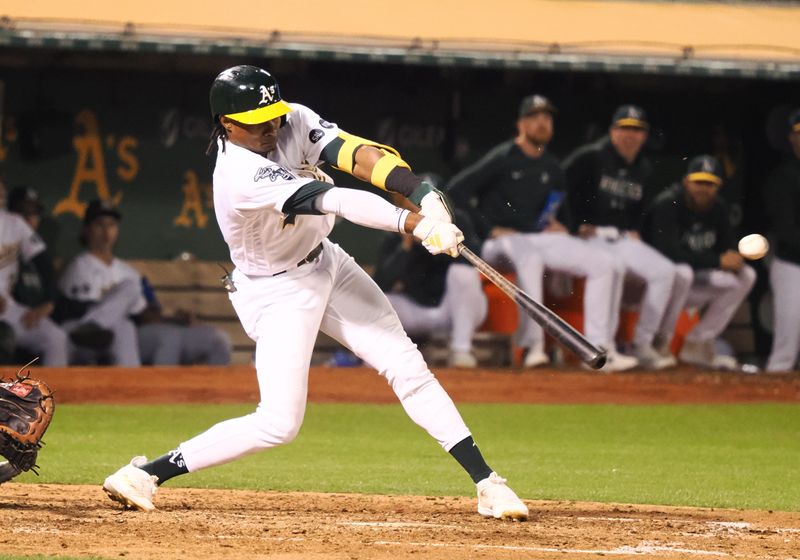 Sep 22, 2023; Oakland, California, USA; Oakland Athletics center fielder Lawrence Butler (22) hits a two-run RBI single against the Detroit Tigers during the seventh inning at Oakland-Alameda County Coliseum. Mandatory Credit: Kelley L Cox-USA TODAY Sports