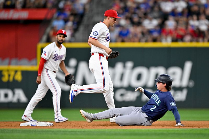 Jun 28, 2025; Arlington, Texas, USA; Texas Rangers shortstop Corey Seager (5) puts out Seattle Mariners second baseman Cole Young (2) at second base to end the third inning at Globe Life Field. Mandatory Credit: Jerome Miron-Imagn Images