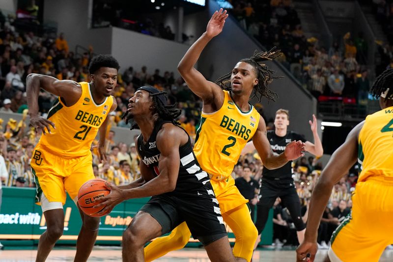 Jan 13, 2024; Waco, Texas, USA; Cincinnati Bearcats guard Day Day Thomas (1) drive the lane past  Baylor Bears guard Jayden Nunn (2) during the first half at Paul and Alejandra Foster Pavilion. Mandatory Credit: Raymond Carlin III-USA TODAY Sports