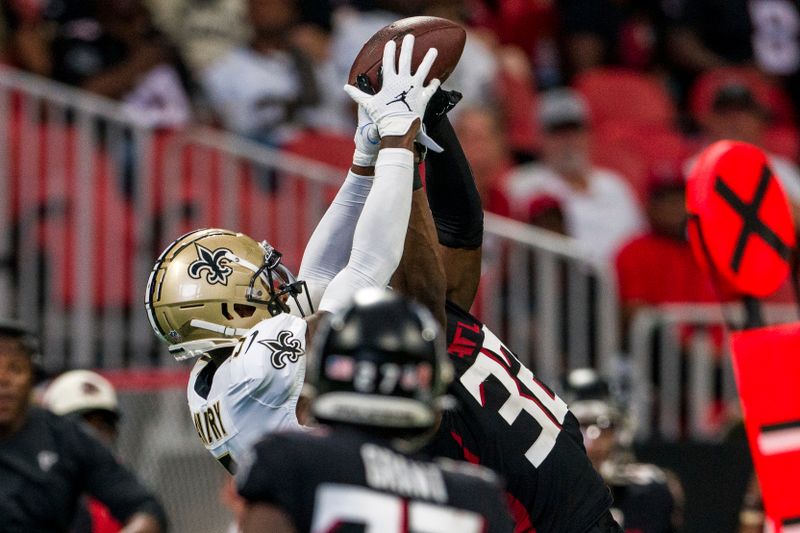 New Orleans Saints wide receiver Jarvis Landry (5) can't make the catch as Atlanta Falcons safety Jaylinn Hawkins (32) defends during the first half of an NFL football game, Sunday, Sep. 11, 2022, in Atlanta. (AP Photo/Danny Karnik)