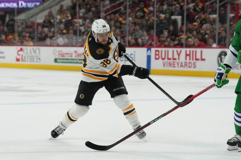 Mar 26, 2023; Raleigh, North Carolina, USA;  Boston Bruins right wing David Pastrnak (88) takes a shot against the Carolina Hurricanes during the second period at PNC Arena. Mandatory Credit: James Guillory-USA TODAY Sports