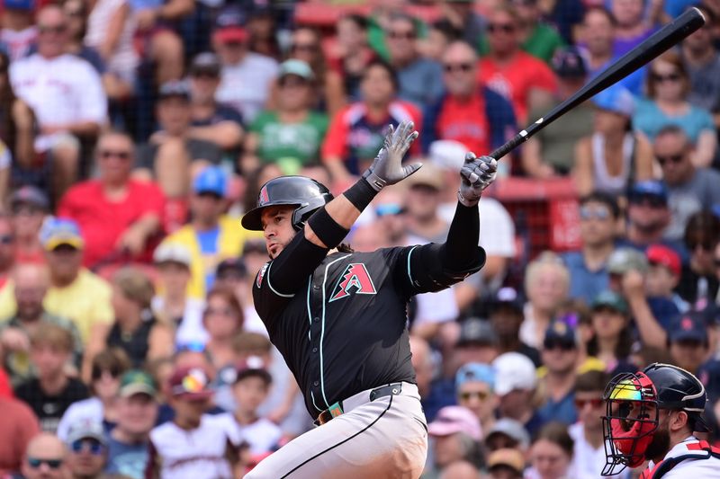 Aug 25, 2024; Boston, Massachusetts, USA; Arizona Diamondbacks third baseman Eugenio Suarez (28) hits a single during the eighth inning against the Boston Red Sox at Fenway Park. Mandatory Credit: Eric Canha-USA TODAY Sports