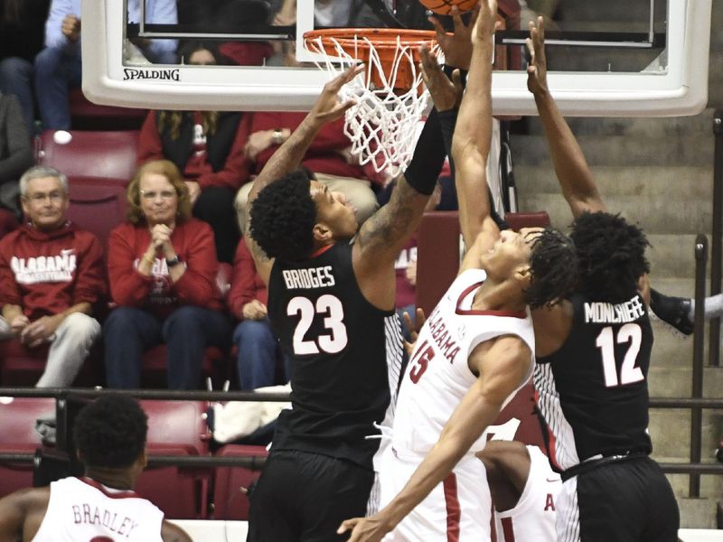 Feb 18, 2023; Tuscaloosa, Alabama, USA; Alabama forward Noah Clowney (15) blocks a shot at the rim from Georgia center Braelen Bridges (23) at Coleman Coliseum. Mandatory Credit: Gary Cosby Jr.-USA TODAY Sports