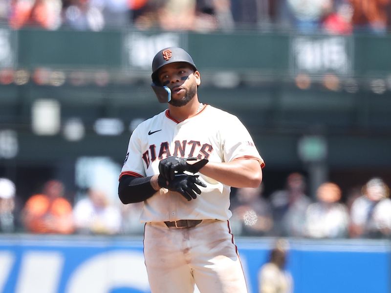 Jun 5, 2025; San Francisco, California, USA; San Francisco Giants first baseman Dominic Smith (7) after hitting a two-run ground rule double against the San Diego Padres during the third inning at Oracle Park. Mandatory Credit: Kelley L Cox-Imagn Images