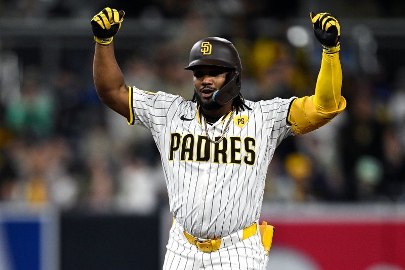 Apr 20, 2024; San Diego, California, USA; San Diego Padres pinch hitter Eguy Rosario (5) celebrates after hitting a double against the Toronto Blue Jays during the seventh inning at Petco Park. Mandatory Credit: Orlando Ramirez-USA TODAY Sports