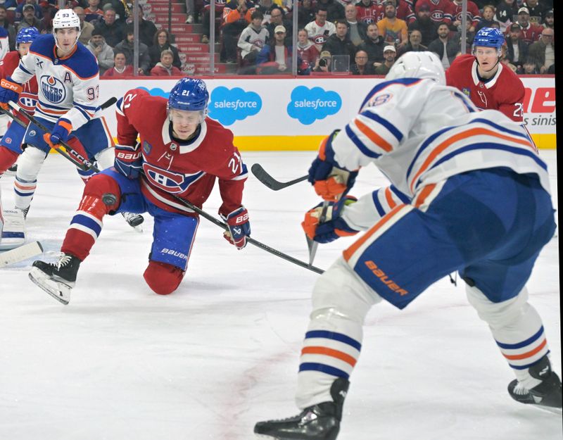 Nov 18, 2024; Montreal, Quebec, CAN;  Montreal Canadiens defenseman Kaiden Guhle (21) blocks a shot from Edmonton Oilers forward Zach Hyman (18) during the first period at the Bell Centre. Mandatory Credit: Eric Bolte-Imagn Images