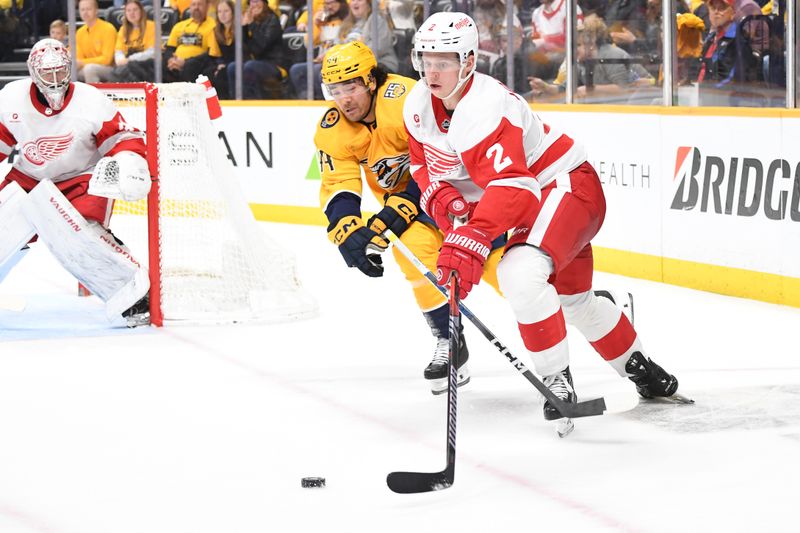 Mar 23, 2024; Nashville, Tennessee, USA; Detroit Red Wings defenseman Olli Maatta (2) plays the puck against Nashville Predators left wing Kiefer Sherwood (44) during the third period at Bridgestone Arena. Mandatory Credit: Christopher Hanewinckel-USA TODAY Sports