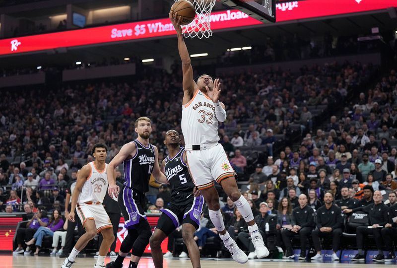 SACRAMENTO, CALIFORNIA - MARCH 07: Tre Jones #33 of the San Antonio Spurs goes in for a layup against Sacramento Kings during the first half at Golden 1 Center on March 07, 2024 in Sacramento, California. NOTE TO USER: User expressly acknowledges and agrees that, by downloading and or using this photograph, User is consenting to the terms and conditions of the Getty Images License Agreement. (Photo by Thearon W. Henderson/Getty Images)